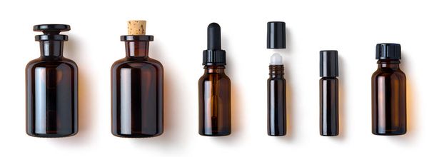 various amber glass bottles for cosmetics, natural medicine , essential oils or other liquids isolated on a white background, top view - Photo, Image