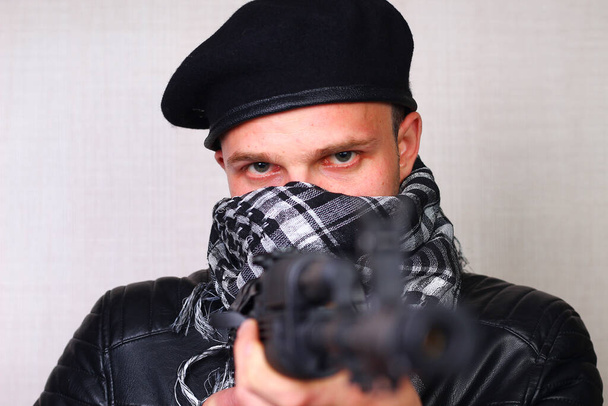 Young man in black leather jacket with assault rifle - Fotografie, Obrázek