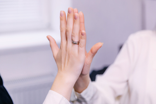 hands of businesswomen giving high five, cropped shot - Фото, зображення
