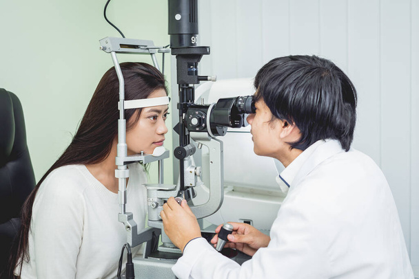 Consultation with an ophthalmologist. Young asian woman and doctor  - Valokuva, kuva