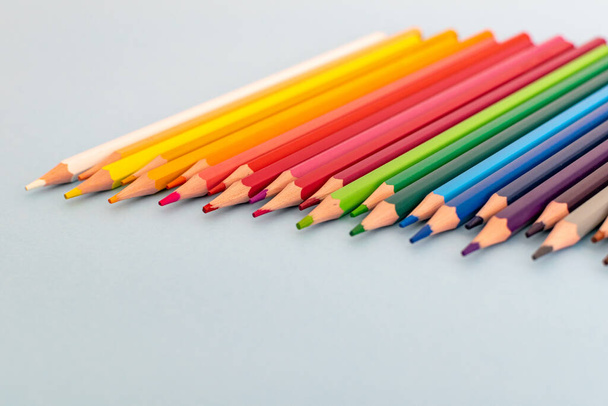 a selection of colourful sharpened pencil lined up on a table - Zdjęcie, obraz