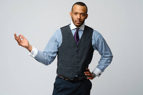 professional african-american business man - presenting points a hand at copy space - 写真・画像