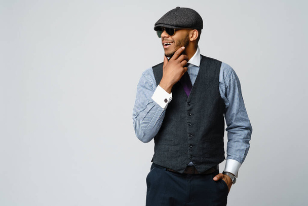 African-American man wearing cap, shirt and tie portrait over grey background - Fotografie, Obrázek