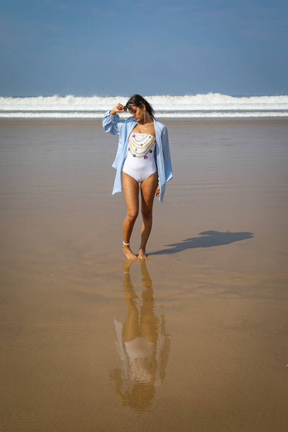Girl on the beach in swimsuit and hat. The Atlantic Ocean Agadir Morocco. - Fotoğraf, Görsel
