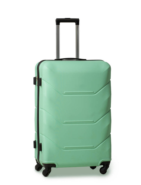 Green suitcase with retractable handle and wheels. Plastic travel luggage suitcase is reliable travel companion. Impressions of new places. Vacation concept. Isolated on white background - Fotó, kép