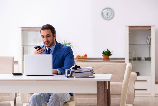 Young male employee working from house in self-isolation concept - Photo, Image