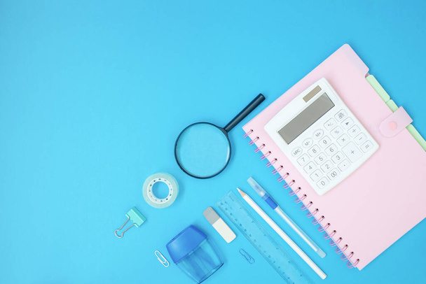 Back to school styled scene with school supplies on blue background. Top view with copy space.  - 写真・画像
