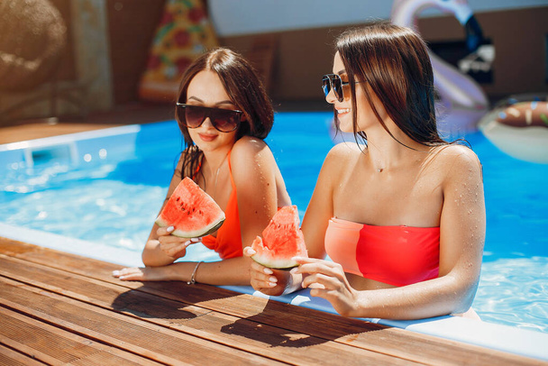 Girls on summer party in the swimming pool - Foto, Bild