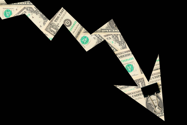 Arrow down from the elements of dollar bills on a black background, isolated. The concept of the global financial crisis, problems in the economy and the trend of falling. - Foto, imagen
