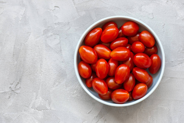Fresh red cherry tomatoes on light background - Fotoğraf, Görsel