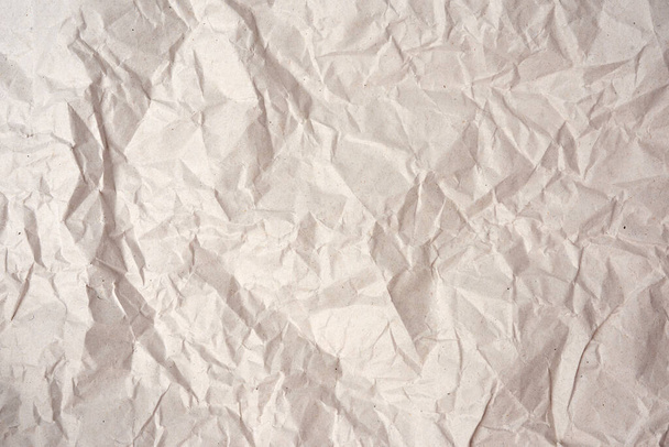 crumpled blank sheet of gray wrapping kraft paper, texture for the designer, full frame - Fotó, kép