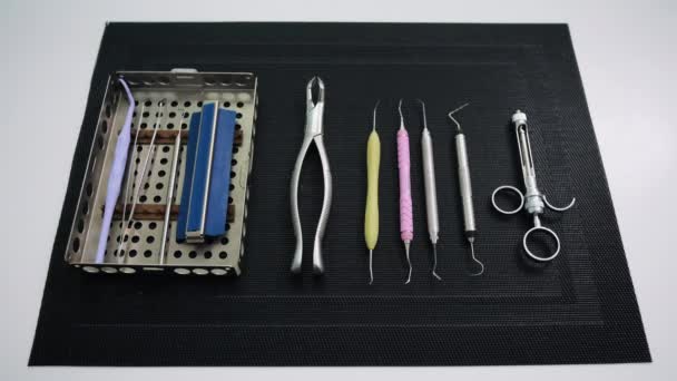 Toma estática de herramientas dentistas en alfombra negra. Cuidado de los dientes, concepto de salud dental
 - Imágenes, Vídeo