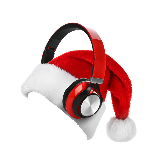 Santa Claus red hat and headphones on white background. Christmas music concept  - Foto, Imagen