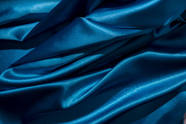 Background image of crumpled fabric. Blue silk - Φωτογραφία, εικόνα