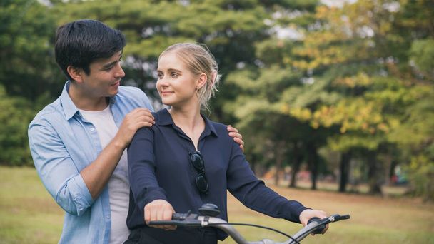 Ευτυχισμένο ζευγάρι κάνει ποδήλατο στο πάρκο.. - Φωτογραφία, εικόνα