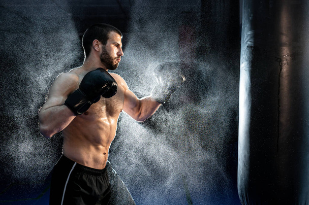 Sportsman boxer fighting on black background with smoke. Boxing sport concept. Shadow fight - Foto, Imagem