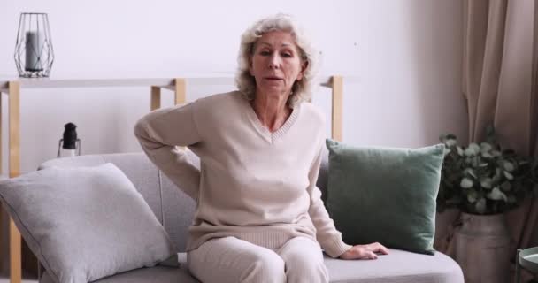 Unhealthy senior mature retired grandmother suffering from osteoporosis arthritis. - Filmati, video