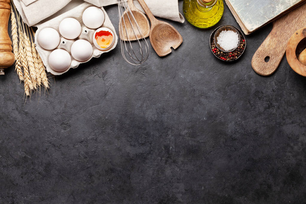 Cooking utensils and ingredients on stone background. Top view with copy space for your recipe. Flat lay - Foto, Bild