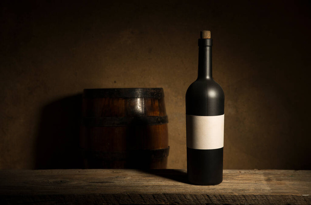 the still life with red wine, bottle, glass and old barrel - Photo, Image