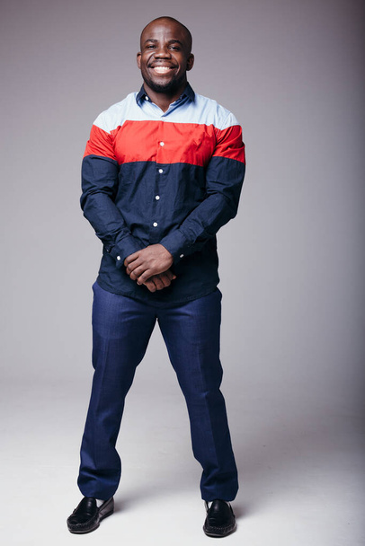 Full-length studio shot of a handsome african american in shirt and jeans - Fotó, kép