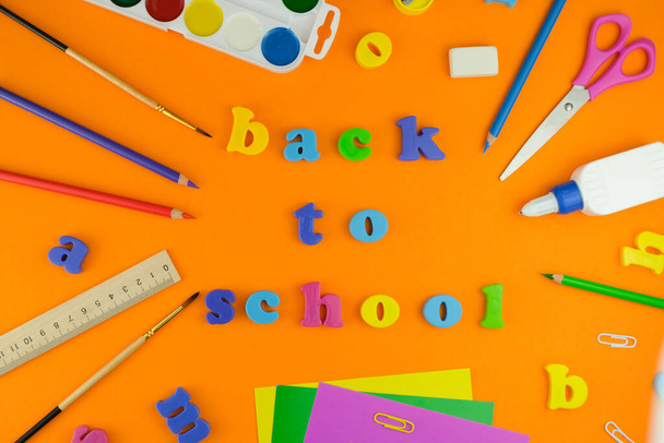 Set of school supplies on orange background. Back to school. - Zdjęcie, obraz