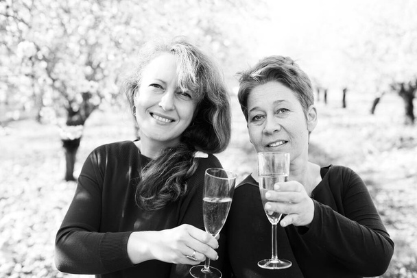 Outdoor portrait of two best friends women celebrating the end of isolation - Photo, Image