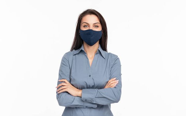 Confident young woman in protective mask looking at camera - Photo, image