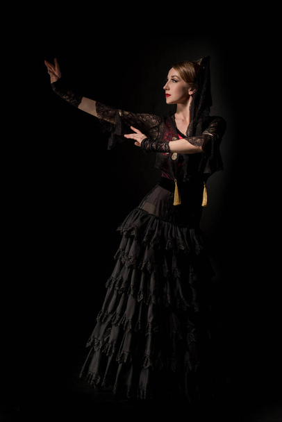 attractive girl dancing flamenco isolated on black - Foto, Imagem