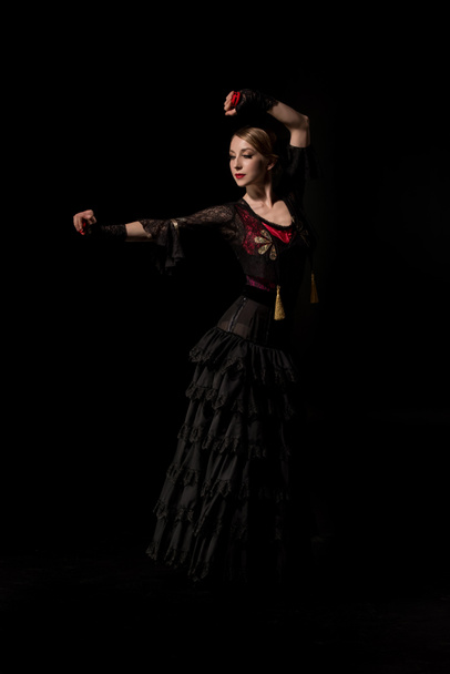 attractive flamenco dancer in dress dancing isolated on black - Photo, Image