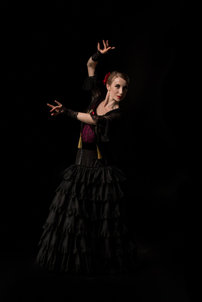 pretty flamenco dancer in dress dancing isolated on black - Foto, afbeelding