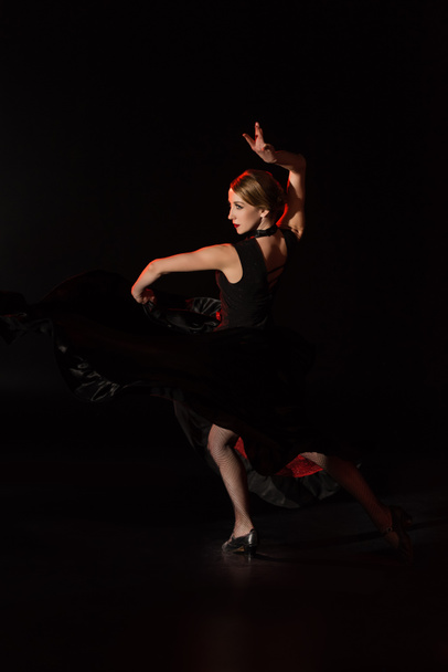 pretty young dancer dancing flamenco on black  - Фото, зображення