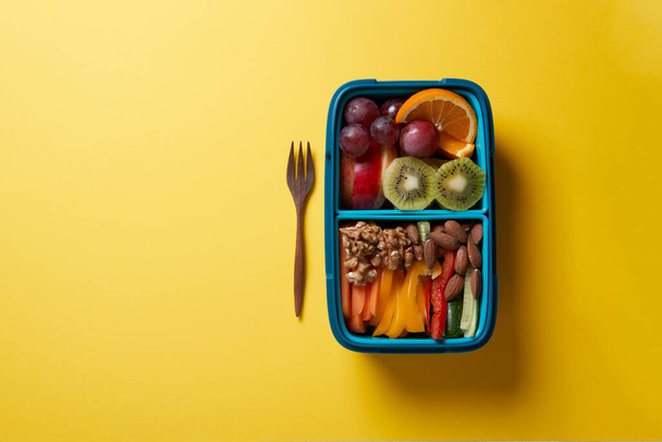 Top View of Full Lunch Box with Fuits, Vegetables and nuts. - Photo, Image