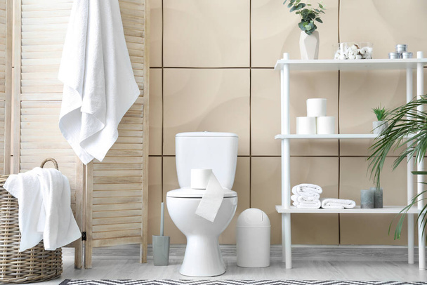 Toilet bowl and rolls of paper in restroom - Photo, Image