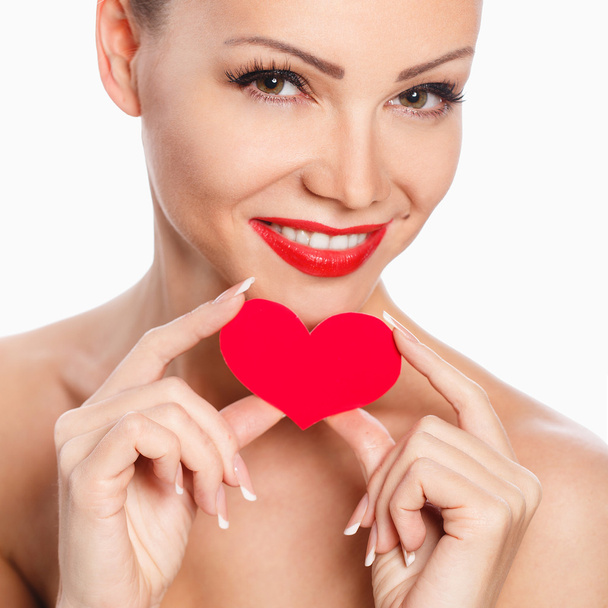 Portrait of Beautiful gorgeous woman with glamour bright makeup and red heart in hand - Фото, изображение
