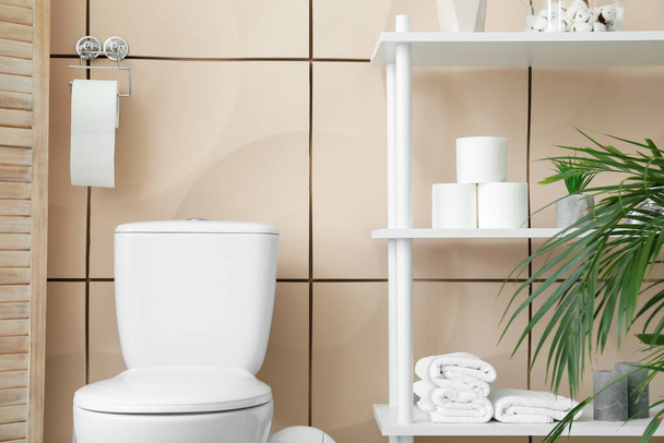 Toilet bowl and rolls of paper in restroom - Foto, Imagem