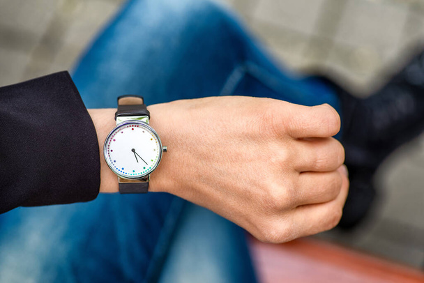 What time is it. Silver wristwatch on hand of woman. - Photo, image