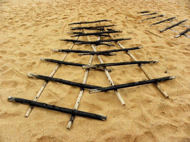 Wood grate. Wooden fixture for storing fishing boats on the shore. - Photo, Image