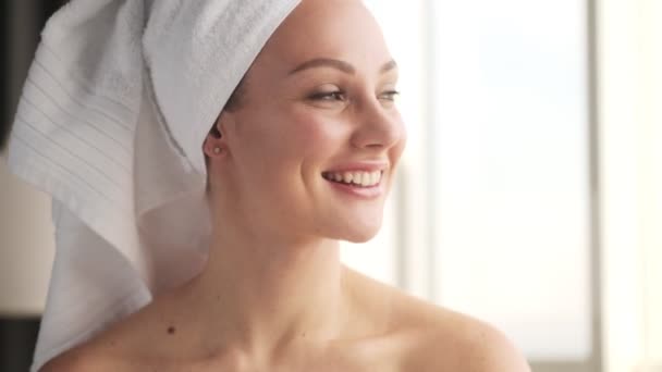 Young optimistic positive woman indoors at home with towel on a head - Filmmaterial, Video
