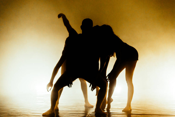 Caucasian male and female contemporary dancers exercising a dance routine - Foto, imagen