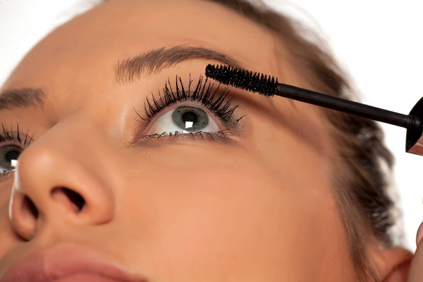 Closeup of young woman applying mascara - Foto, immagini