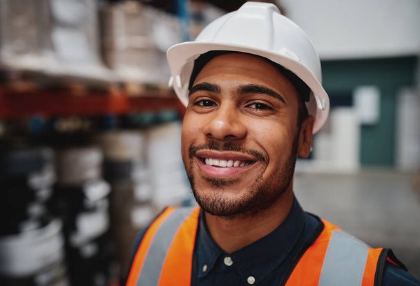 Portrait of smiling warehouse supervisor wearing white helmet hard hat smiling at the camera  - Zdjęcie, obraz