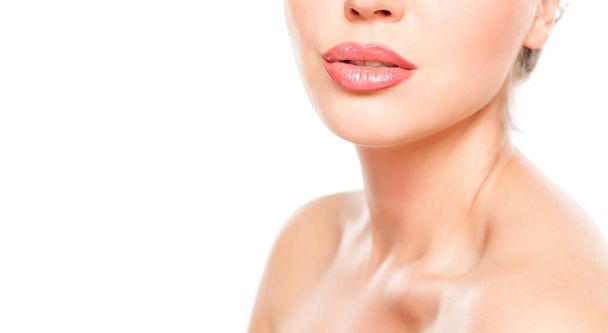 beautiful female lips with lip gloss and nacked shoulders on white background - Fotografie, Obrázek