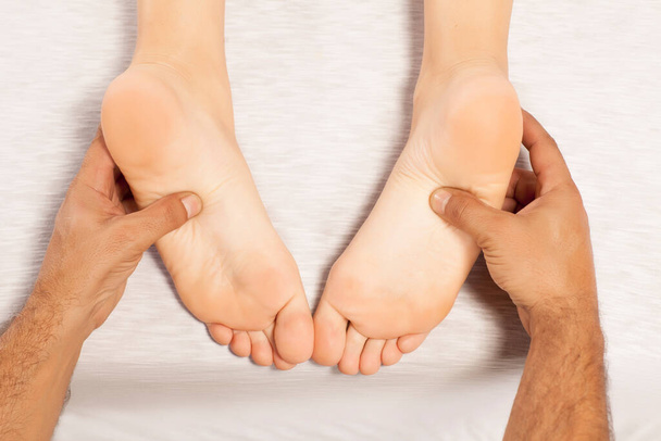 reflexology and acupressure on women's feet - Photo, image
