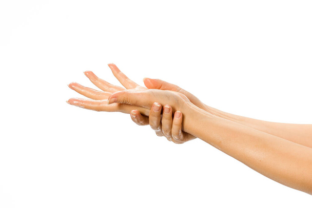 közelkép a női kéz alkalmazó kézkrém fehér háttér - Fotó, kép