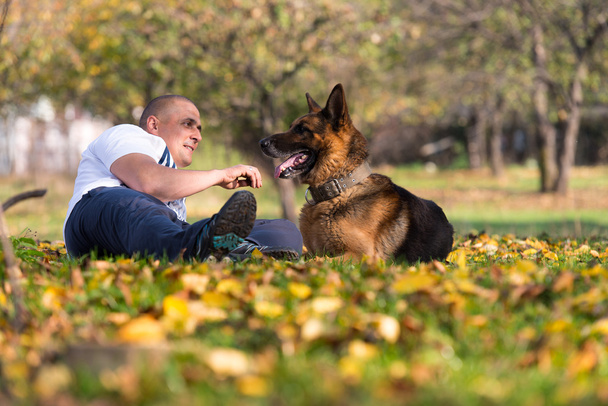 Man Holding Dog German Shepherd - 写真・画像