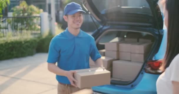 Delivery service male in uniform give cardboard box package to receiver customer client front home, fast express offsite when crisis coronavirus, covid19 new normal lifestyle concept. - Footage, Video