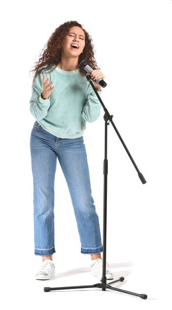 Young African-American woman singing on white background - Photo, Image