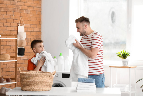 Man and his little son doing laundry at home - Photo, Image