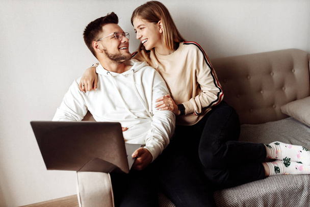 young couple communicating with friends online at home - Photo, Image
