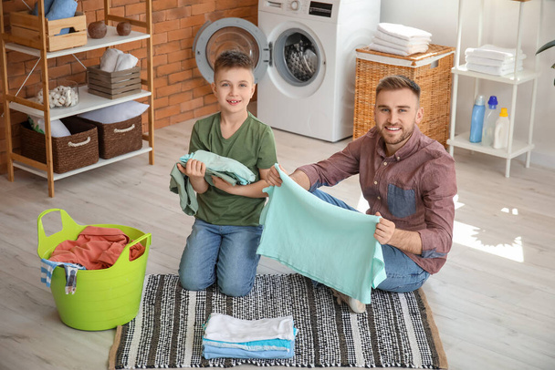 Man and his little son doing laundry at home - Photo, Image